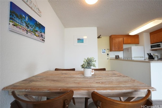 dining area featuring a textured ceiling