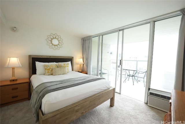 carpeted bedroom featuring access to outside and a wall mounted AC