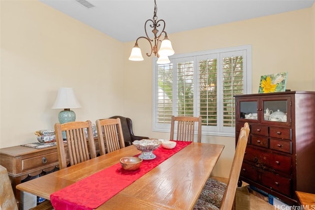 dining area with an inviting chandelier