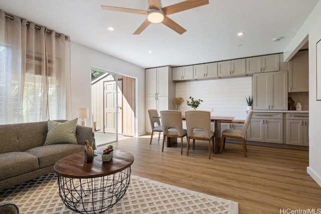 living room featuring ceiling fan and light hardwood / wood-style floors