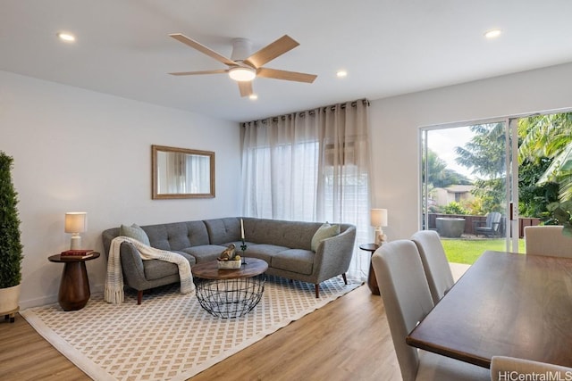 living room featuring ceiling fan and hardwood / wood-style flooring