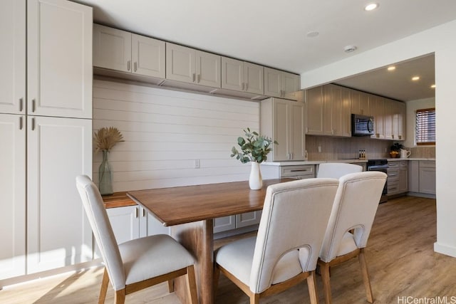 dining space with light hardwood / wood-style flooring