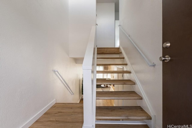 stairs with hardwood / wood-style flooring