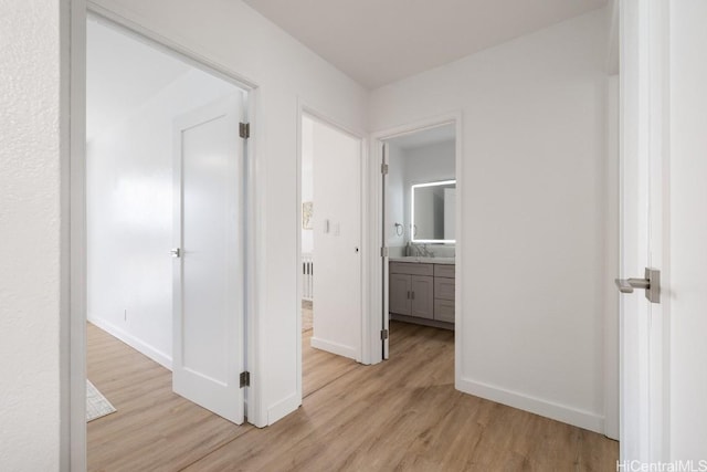 hall featuring light hardwood / wood-style flooring and sink