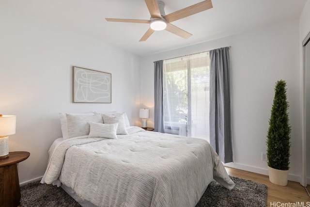 bedroom with ceiling fan and light hardwood / wood-style flooring