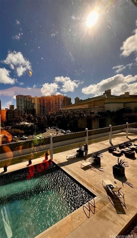 exterior space with a pool and a patio area