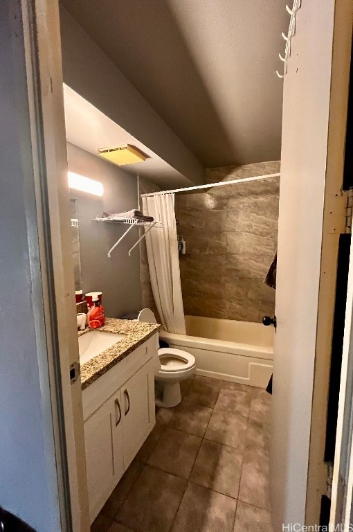 full bathroom featuring vanity, toilet, tile patterned flooring, and shower / bath combo with shower curtain