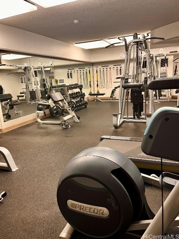 exercise room with a textured ceiling