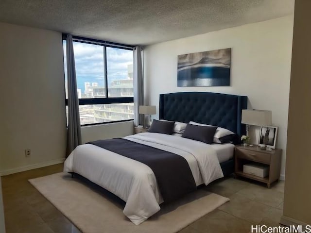 bedroom featuring tile patterned flooring and a textured ceiling