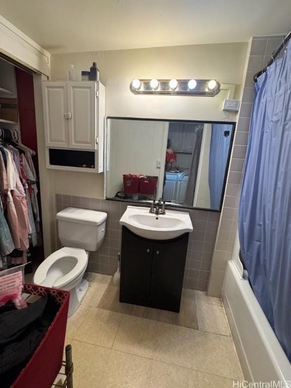 full bathroom featuring tile patterned flooring, vanity, tile walls, and shower / bath combo with shower curtain