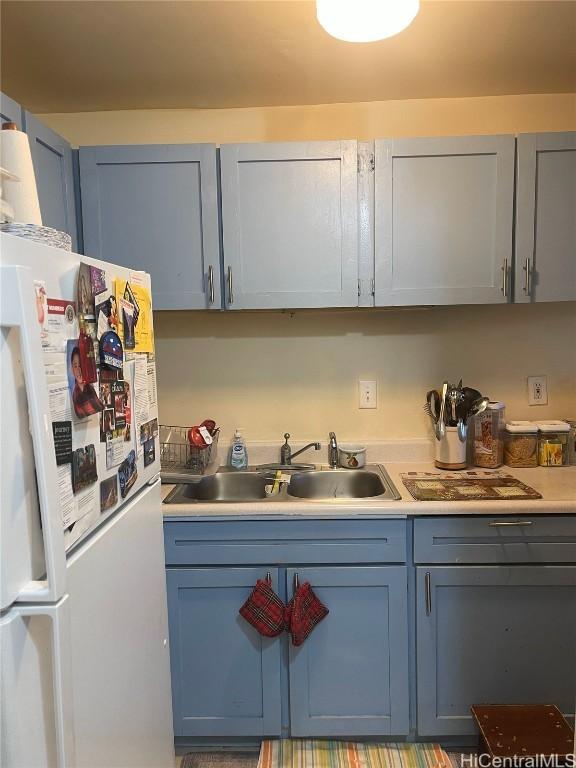 kitchen with white refrigerator and sink