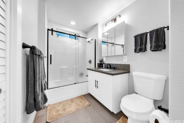 full bathroom with vanity, toilet, and shower / bath combination with glass door