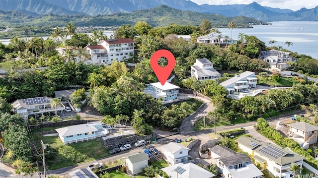 birds eye view of property with a water and mountain view