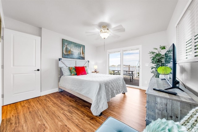 bedroom with wood-type flooring, access to outside, and ceiling fan