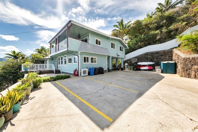 exterior space with a balcony and ac unit