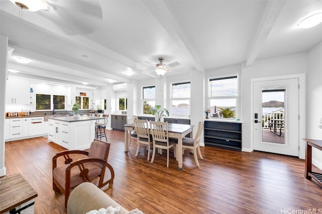 dining room featuring beamed ceiling, ceiling fan, wood-type flooring, and an AC wall unit