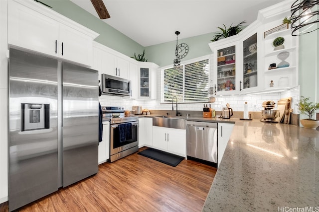 kitchen featuring pendant lighting, white cabinetry, and stainless steel appliances