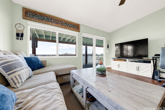 living room with hardwood / wood-style flooring, ceiling fan, and lofted ceiling