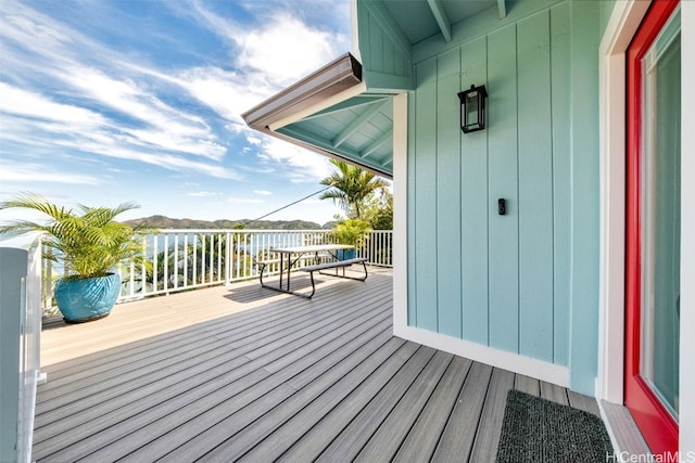 wooden terrace featuring a water view