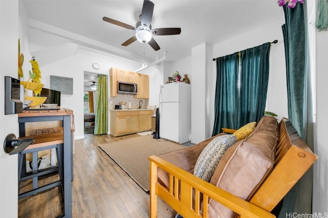 living room with ceiling fan and light wood-type flooring