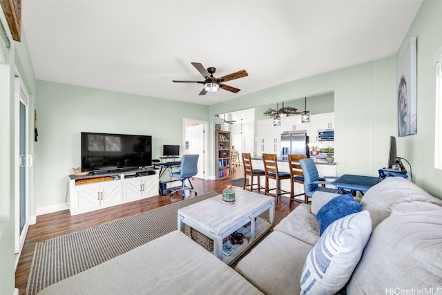 living room featuring ceiling fan and wood-type flooring