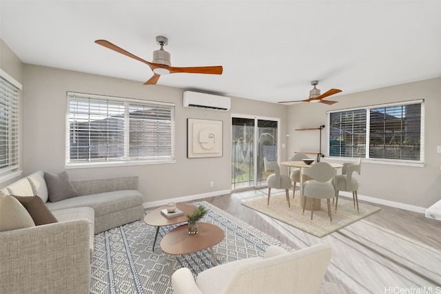 living room featuring ceiling fan, light hardwood / wood-style floors, and an AC wall unit