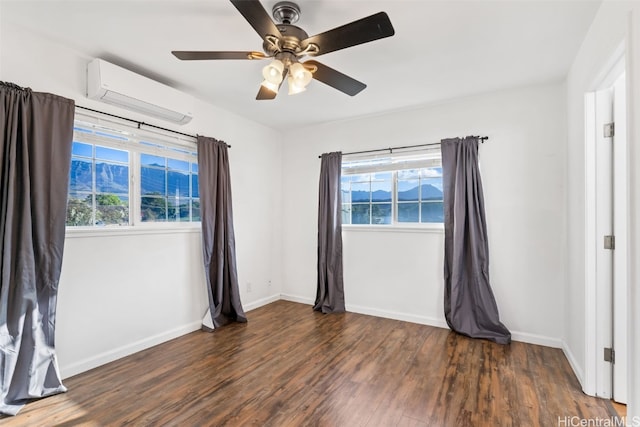 empty room with ceiling fan, dark hardwood / wood-style flooring, and a wall mounted air conditioner