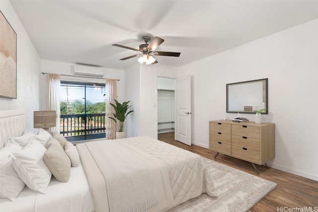 bedroom with ceiling fan, baseboard heating, dark hardwood / wood-style floors, a wall unit AC, and access to outside