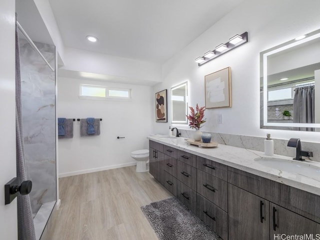 bathroom with vanity, toilet, wood-type flooring, and walk in shower