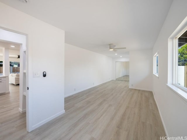 unfurnished room featuring ceiling fan and light hardwood / wood-style flooring