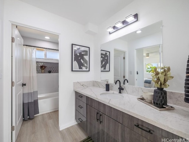 bathroom with vanity, shower / bath combo, and hardwood / wood-style flooring