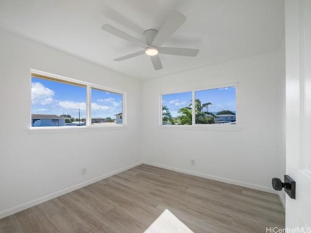 unfurnished room with ceiling fan and light hardwood / wood-style flooring