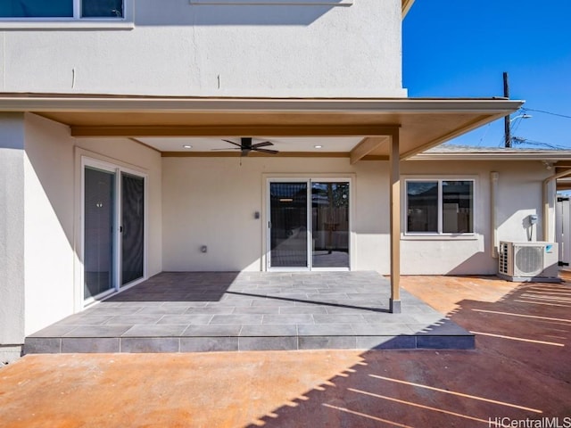 exterior space with ac unit, ceiling fan, and a patio area