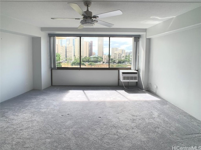 unfurnished room with ceiling fan, carpet floors, and an AC wall unit