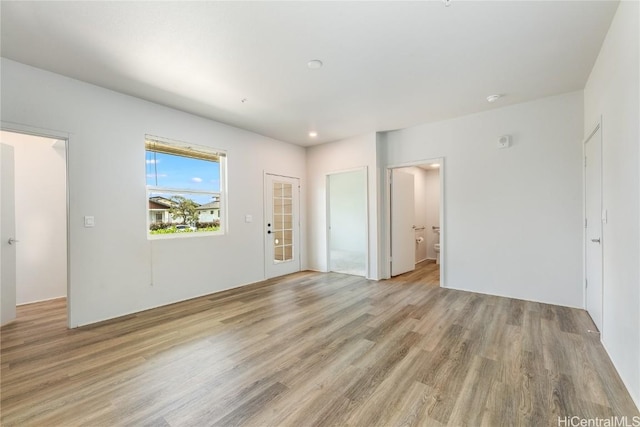 empty room with light hardwood / wood-style flooring