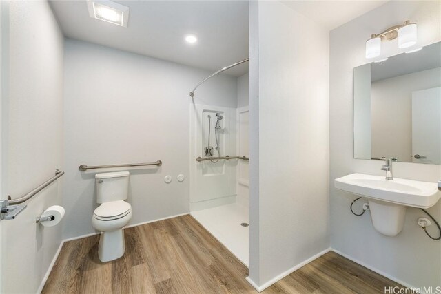 bathroom with walk in shower, toilet, and hardwood / wood-style flooring