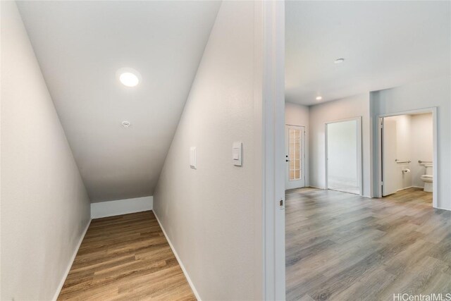 corridor with hardwood / wood-style flooring