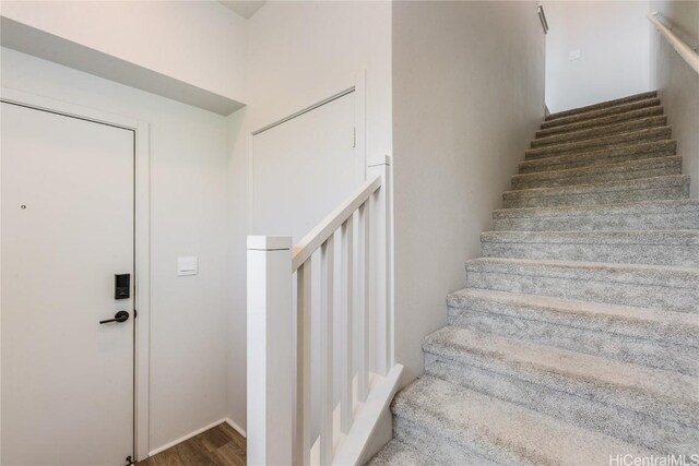 stairs featuring hardwood / wood-style flooring