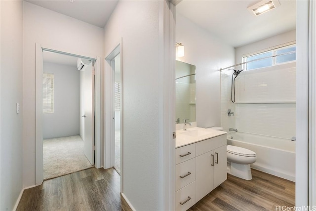 full bathroom featuring toilet, hardwood / wood-style floors, vanity, and tub / shower combination