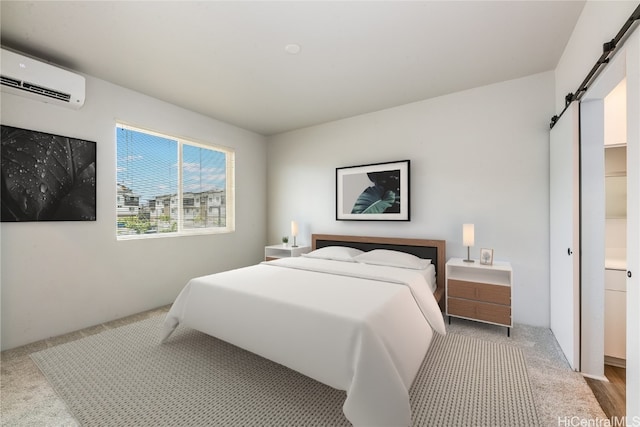 carpeted bedroom featuring a barn door and a wall mounted air conditioner