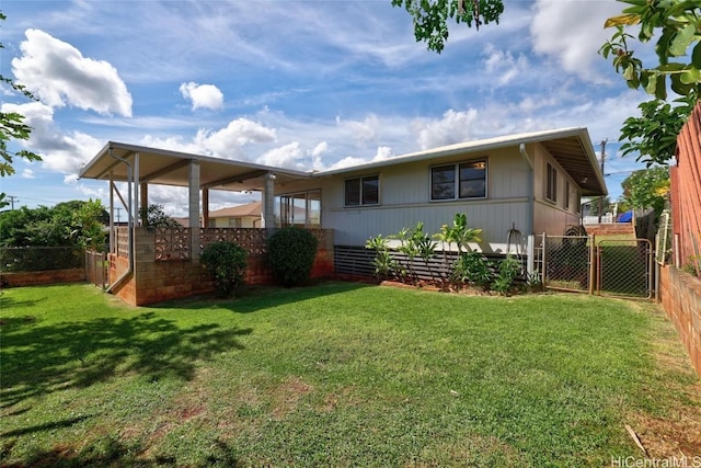 rear view of property with a yard