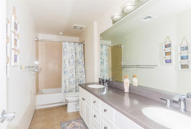 full bathroom with tile patterned floors, shower / tub combo with curtain, vanity, and toilet