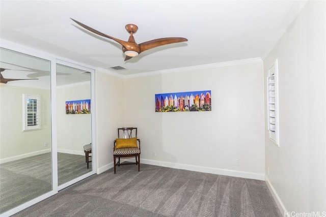 unfurnished room featuring dark colored carpet, ceiling fan, and crown molding