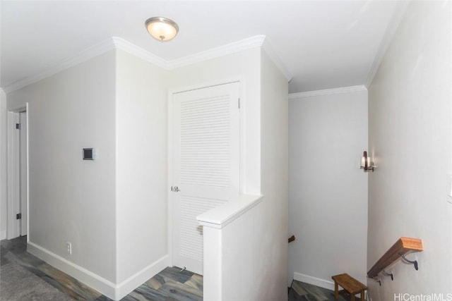 laundry area with dark wood-type flooring and ornamental molding