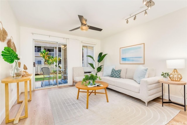 living room with ceiling fan and light hardwood / wood-style floors