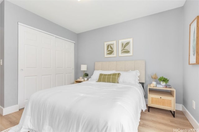 bedroom featuring light hardwood / wood-style floors and a closet