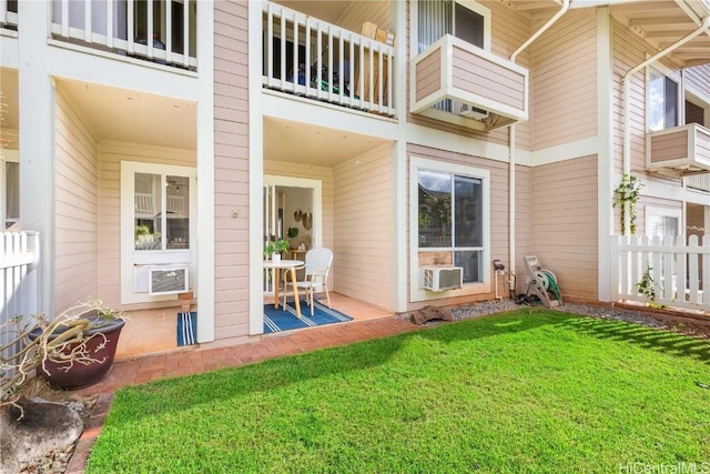 exterior space with a yard, cooling unit, and a patio area