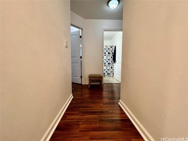 hallway with dark hardwood / wood-style floors