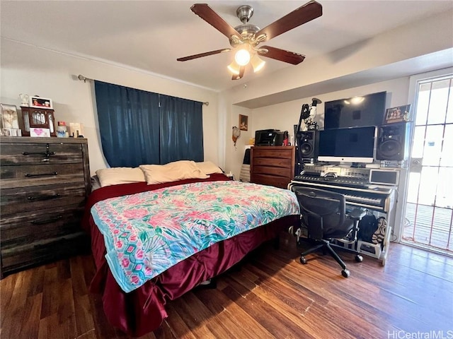 bedroom with ceiling fan and dark hardwood / wood-style flooring