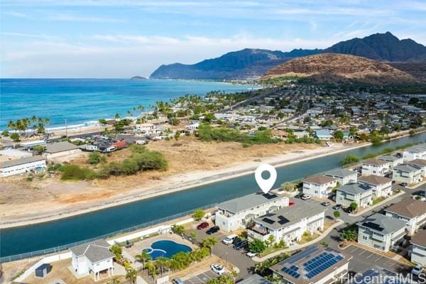 drone / aerial view with a water and mountain view